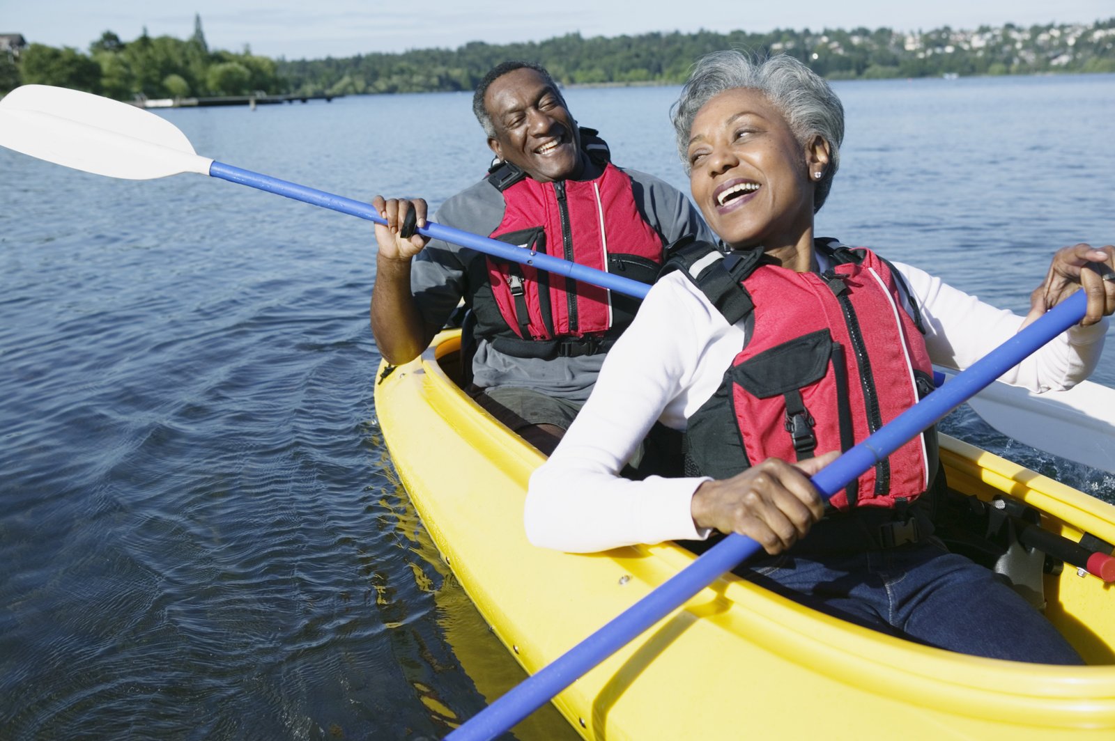 Active retirement couple kayaking — the lifestyle freedom reverse mortgage proceeds can support